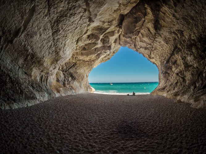 A picture of the beach taken from inside a cave in Sardinia