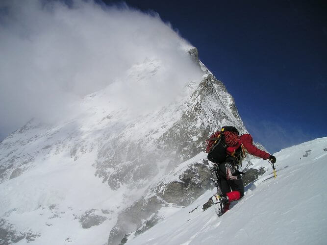 An image of a trekker in an Alpine environment