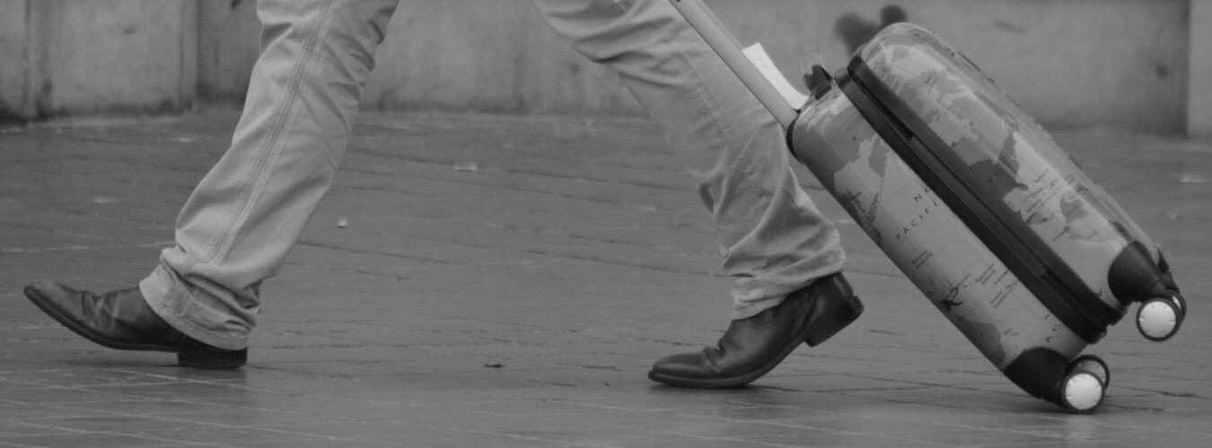 A picture of a man carrying the best carry on luggage in the market today