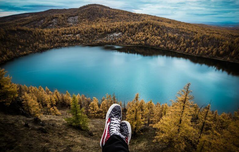 A shot of a person staring at a beautiful lake