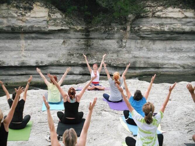 Group of travelers doing Yoga
