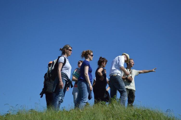 Group of tourists are seen here being helped by a guide