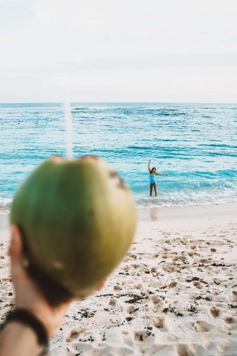 Sipping coconut on the beach