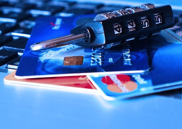 An image of a TSA lock over some credit cards - symbolizing security