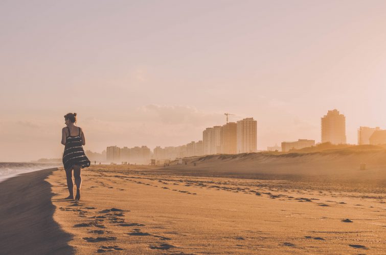 Woman walking on city beach