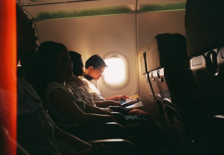 Person reading magazine on a plane