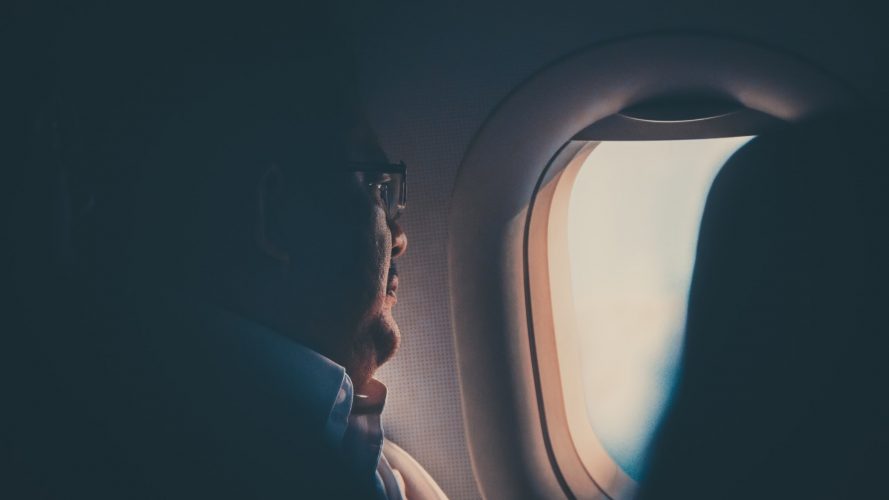 Man looking out of airplane window