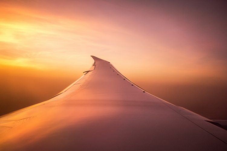 Sunset over the wing of a plane